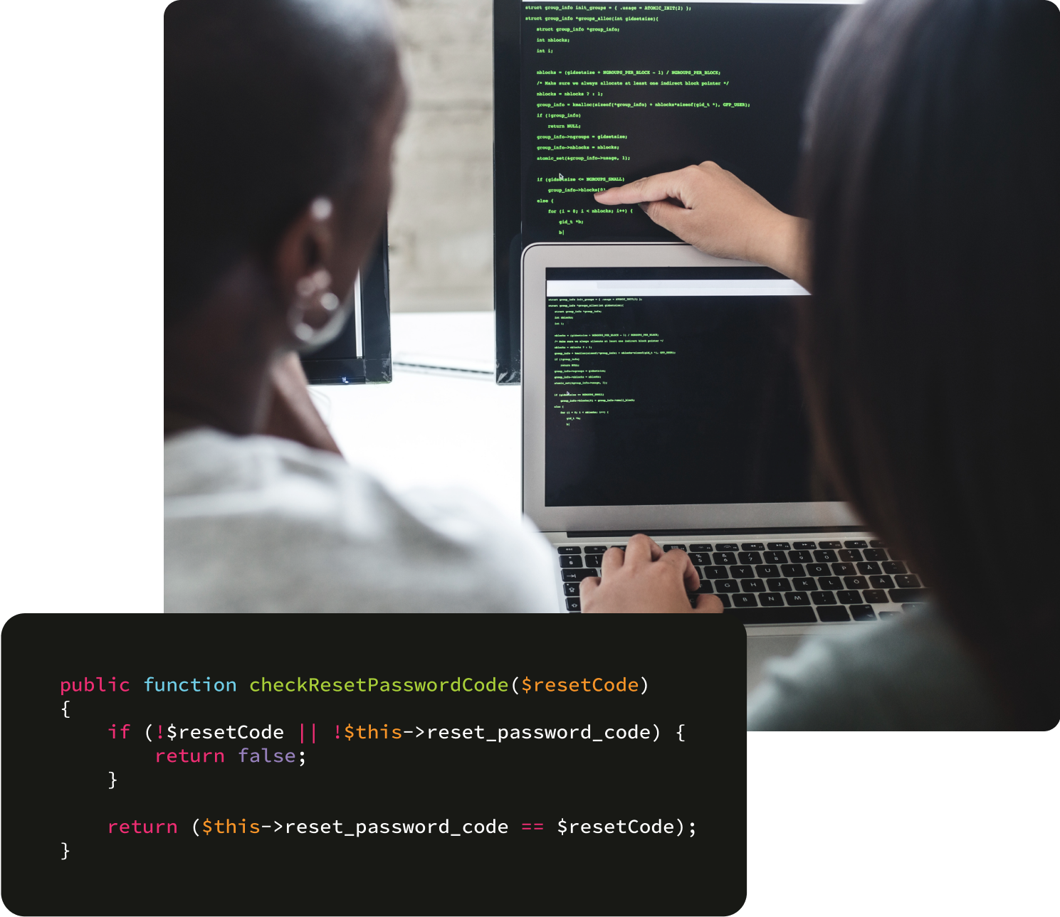 Two people looking at computer code, accessing cybersecurity.